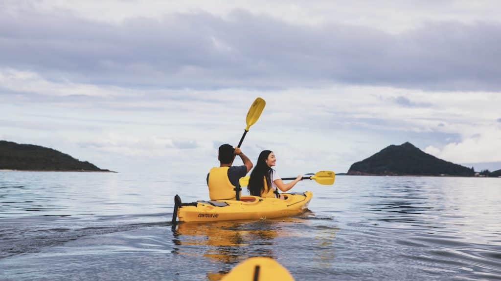 Couple enjoying a day of kayaking along the Karuah River off Jimmys Beach, Hawks Nest (Destination NSW)