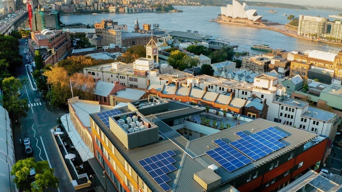Solar panels on the rooftop of YHA Sydney Harbour with views across the harbour to the Sydney Opera House.