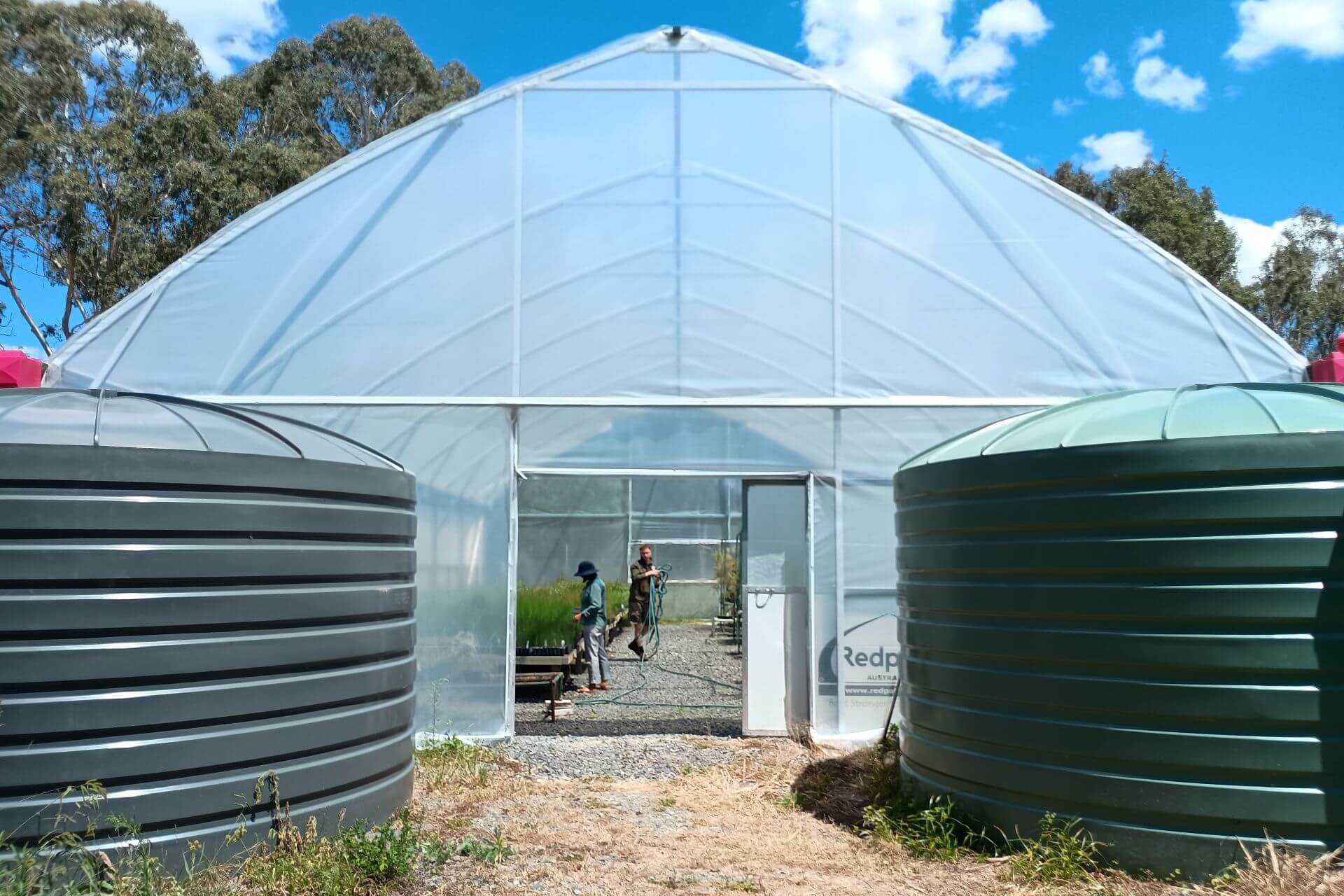 Water tanks at the entrance of the new greenhouse.