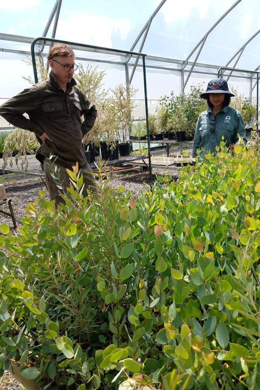 Zac from ATG and Thaw from SNEL inspecting plants in greenhouse. Credit SNEL
